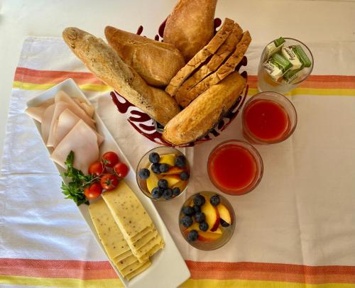 a table with bread and other foods on it at Nelli's B&B in Cospicua