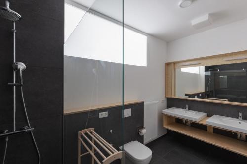 a bathroom with a shower and a sink and a mirror at Künstlerhaus in Niebüll