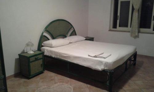 a bedroom with a bed with two napkins on it at in COLLINA di Reggio Calabria villetta in Orti