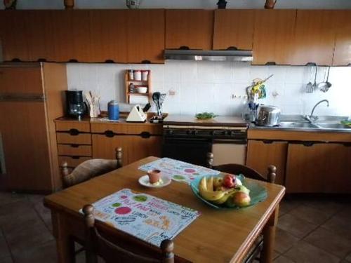 a kitchen with a table with a bowl of fruit on it at in COLLINA di Reggio Calabria villetta in Orti