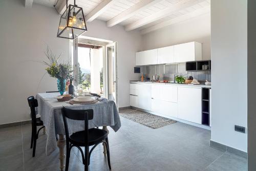 a kitchen with a table and chairs in a room at BORGO DEL FRANCO in Castellabate