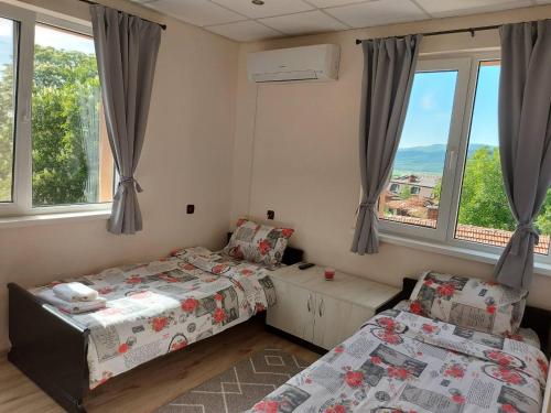 a bedroom with two beds and a window at Bubolina House in Sapareva Banya