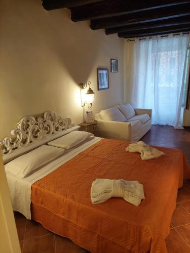 a bedroom with a large bed and a couch at Casa Vacanze Campo de' Fiori in Rome