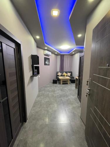 a room with a blue ceiling with a couch and a door at COMFORTABLE APARTMENT КОМФОРТНЫЕ АПАРТАМЕНТЫ Self Check In in Yerevan