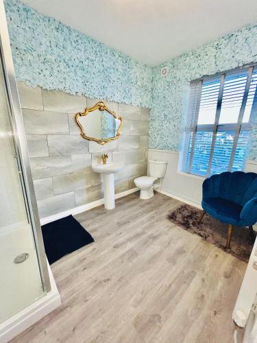 a bathroom with a toilet and a sink and a mirror at Monopoly Holiday Home in Blackpool