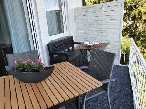 a table and chairs on a porch with a table and flowers at Ferienwohnung Schlossblick Bad Breisig in Bad Breisig