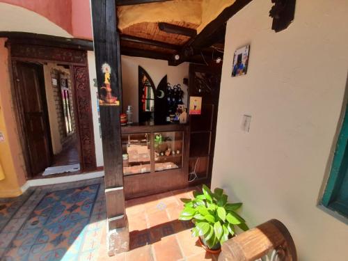 a hallway of a house with a store at Hotel Boutique La Cueva de la Luna, El Arte se hace Descanso in Duitama