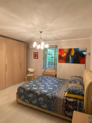 une chambre avec un lit et un lustre dans l'établissement Pavillon d'Angleterre au cœur de la ville, à Menton