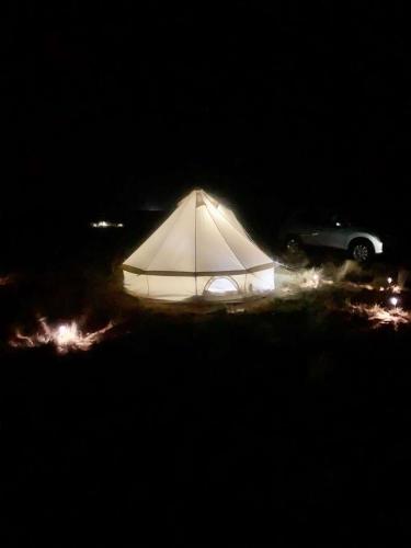 a white tent in a field at night at Starlight Tent 3 in Holbrook