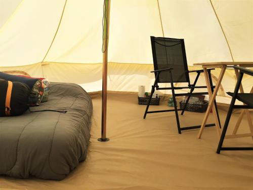 a room with a tent with a table and a chair at Starlight Tent 3 in Holbrook