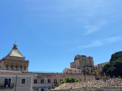 a view of a building with a castle in the background at La Piccola Formica Charme Rooms in Palermo