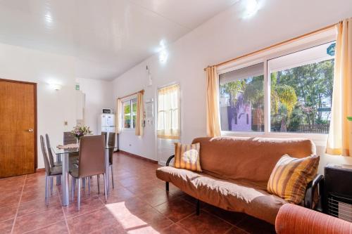 a living room with a couch and a table at Las Coloniales in Sauce de Portezuelo