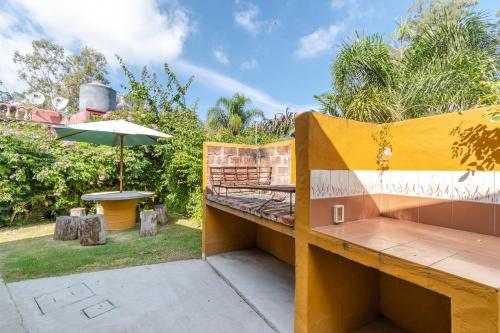 a patio with a table and an umbrella at Las Coloniales in Sauce de Portezuelo