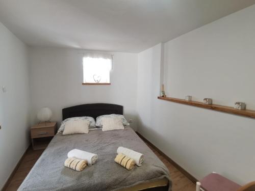 a bedroom with a bed with two towels on it at Apartment Maja in Bribir