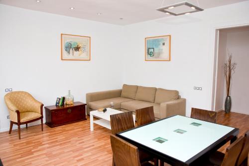 a living room with a couch and a table at Claris Apartments in Barcelona