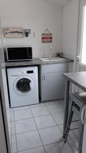 a kitchen with a washing machine and a sink at Villa Moris in Dolus-d'Oléron