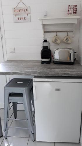 a kitchen counter with a table and a toaster at Villa Moris in Dolus d'Oléron