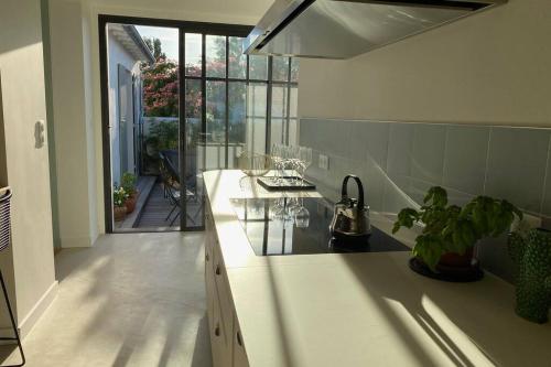 a kitchen with a sink and a counter top at Elégante maison d'architecte, Spa à débordement in La Noue