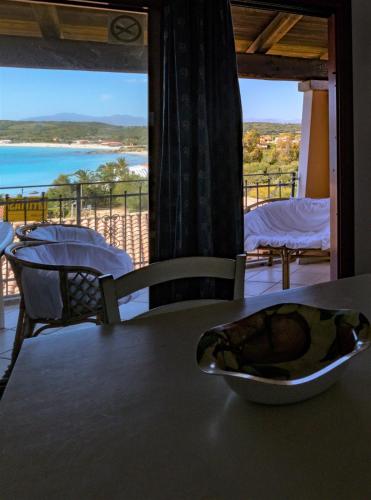 a bowl on a table with a view of the ocean at CASA MAESTRALE - Vista mare Pittulongu - Sardegna - IUN R2217 in Olbia