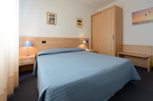 Hotel Ciao Bed & Breakfast tesisinde bir odada yatak veya yataklar