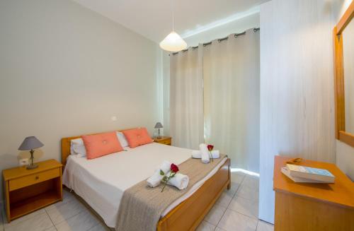 a bedroom with a bed with flowers on it at Giannarakis Beach in Stalos