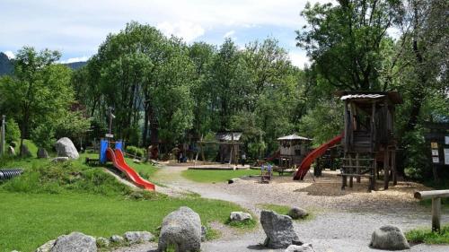 a park with a playground with a slide at Apart Kröll in Schlitters