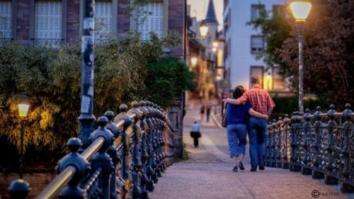 a man and a woman walking down a sidewalk at Hotel Suisse in Strasbourg