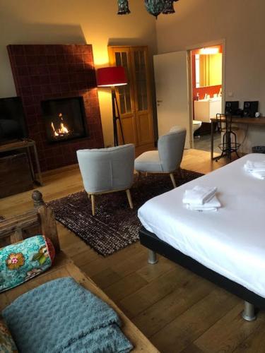 a living room with a bed and a fireplace at House of Bruges in Bruges