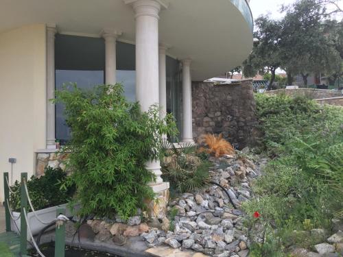 a house with a rock garden in front of it at La Casa del Tejado Verde Toledo in Toledo
