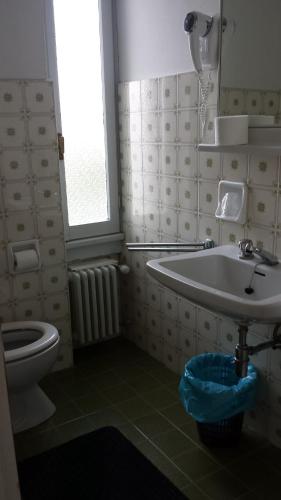 a bathroom with a sink and a toilet and a window at LOCANDA MIRABEAU in Bellagio