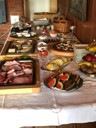 a buffet with many different types of food on a table at Landhaus Jägerhof in Börnsdorf