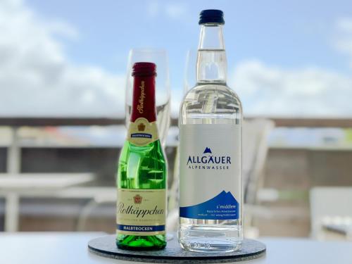 two bottles of alcohol sitting on a table at FeWo Längl -Alpenguck- mit Pool und Sauna im Allgäu in Scheidegg