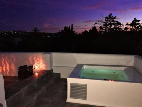 a jacuzzi tub on the side of a house at Ninemia Naxos Suites in Naxos Chora