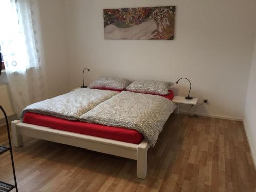 a bedroom with a bed and a painting on the wall at Fewo Moselblick in Traben-Trarbach