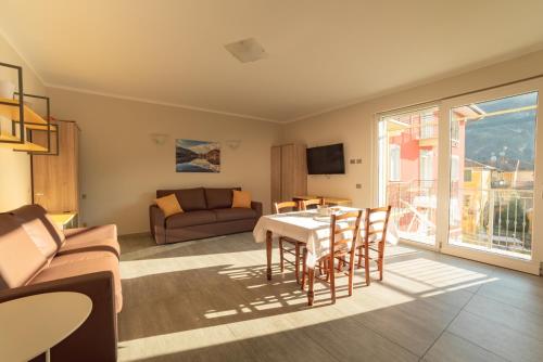 a living room with a table and a couch at Yachting Residence in Lavena Ponte Tresa