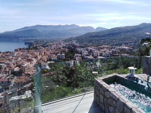 a view of a city from the balcony of a house at Grand Hotel President in Sorrento