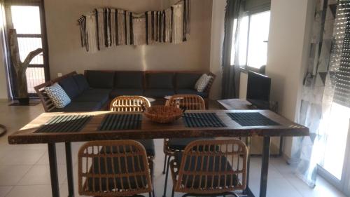 a living room with a couch and a table and chairs at Chrisambelos Apartments in Istro