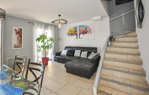 - un salon avec un canapé noir et un escalier dans l'établissement 2 Bedroom Stunning Home In La Farlede, à La Farlède