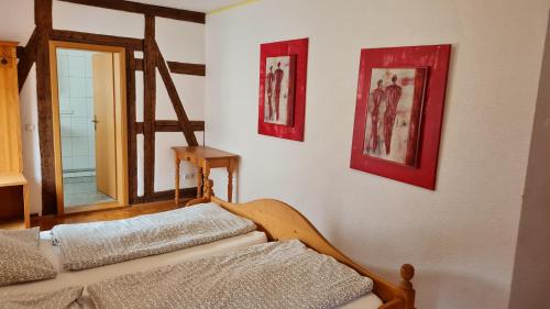 a room with a bed and two pictures on the wall at Hotel Kartäuser Hof Mainz Bodenheim in Bodenheim