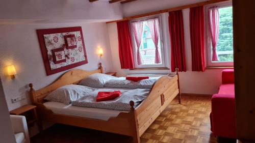 a bedroom with two beds with red pillows on them at Hotel Kartäuser Hof Mainz Bodenheim in Bodenheim