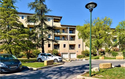a street light and a car parked in front of a building at 2 Bedroom Amazing Apartment In Uzes in Uzès
