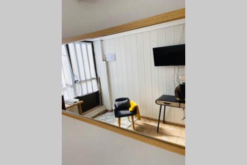 a mirror in a room with a chair and a table at Casa El calado in Viguera