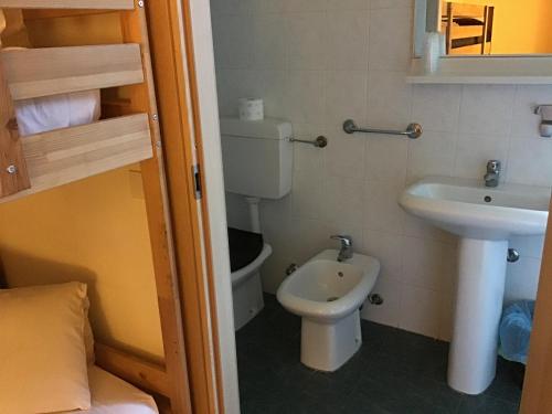 małą łazienkę z toaletą i umywalką w obiekcie OSTELLO MIRABEAU w mieście Bellagio