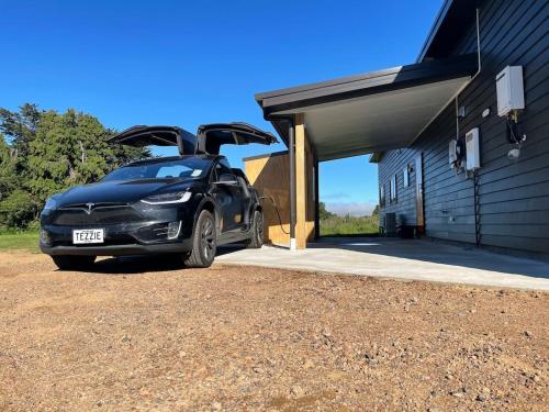 a car parked outside of a building with its door open at Ohakune Solar on Snowmass in Ohakune