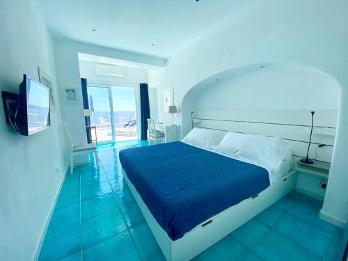 a bedroom with a bed and a television in a room at Hotel Casa Sofia in Ischia
