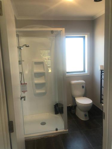 a bathroom with a shower and a toilet at Ohakune Solar on Snowmass in Ohakune