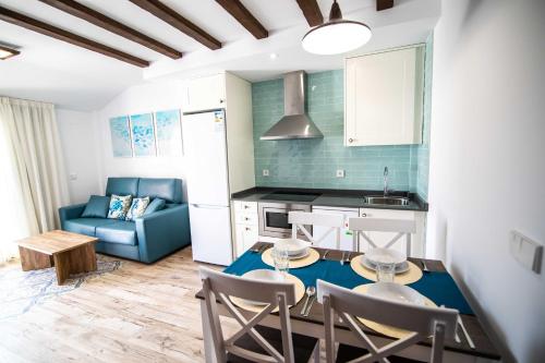 a kitchen and living room with a table and chairs at Maremar Suites in Benidorm