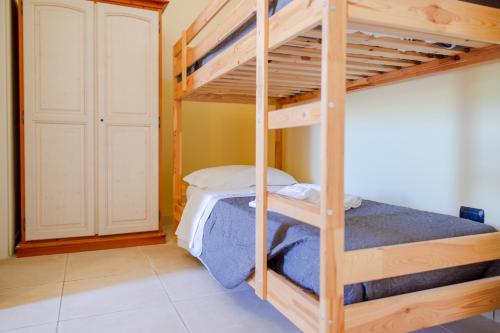 a bedroom with two bunk beds in a room at Delle Rose, Hotel & Horse Riding in Torre Vado
