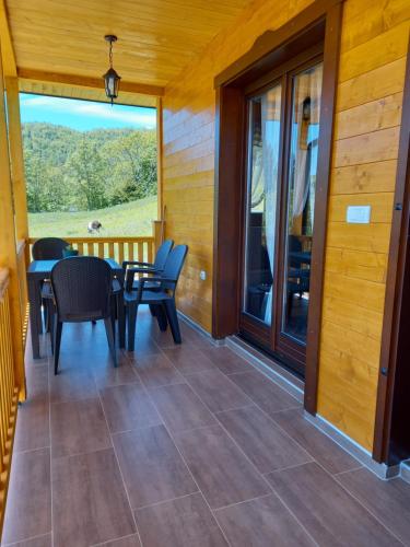 a screened in porch with a table and chairs at Turizam Koturovic in Ivanjica