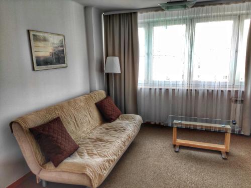a living room with a couch and a table at Hotel Logos in Warsaw